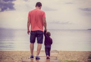 Vater allein mit Kind am Strand.